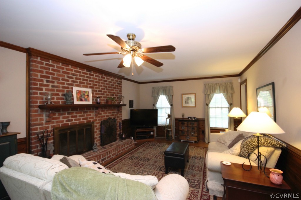 5200 Copperpenny Road Chesterfield, VA 23832 - Photo 8 of 24 a living room with furniture a fireplace and a flat screen tv