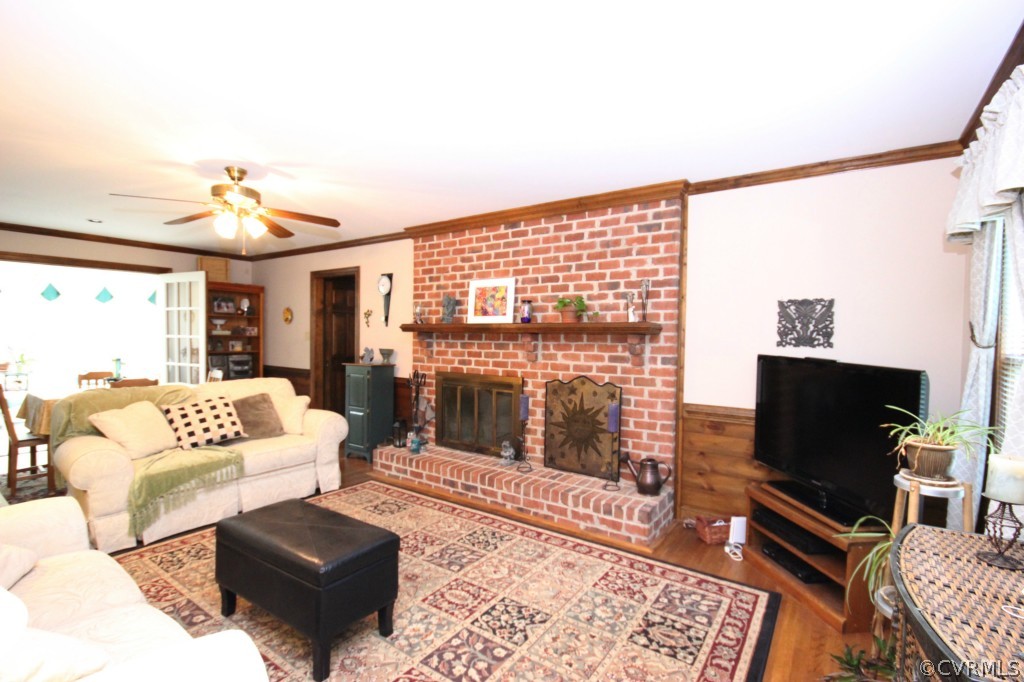 5200 Copperpenny Road Chesterfield, VA 23832 - Photo 9 of 24 a living room with furniture a rug and a flat screen tv