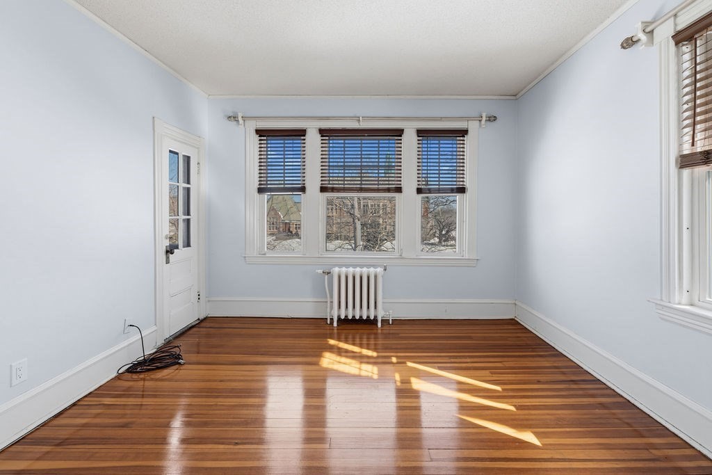 138 South Main Street, Unit 13 Fairhaven, MA 02719 - Photo 11 of 31 a view of an empty room with wooden floor and a window