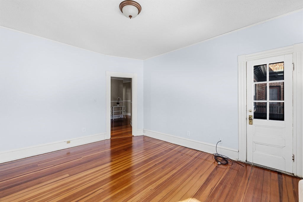 138 South Main Street, Unit 13 Fairhaven, MA 02719 - Photo 12 of 31 an empty room with wooden floor and windows