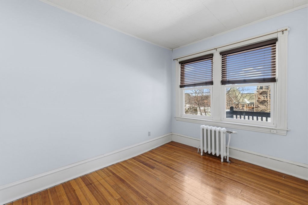 138 South Main Street, Unit 13 Fairhaven, MA 02719 - Photo 13 of 31 an empty room with wooden floor and windows