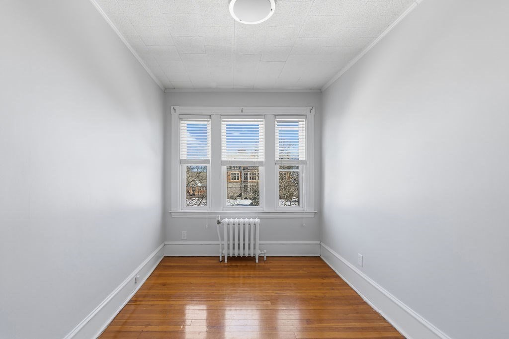 138 South Main Street, Unit 13 Fairhaven, MA 02719 - Photo 14 of 31 an empty room with wooden floor and windows