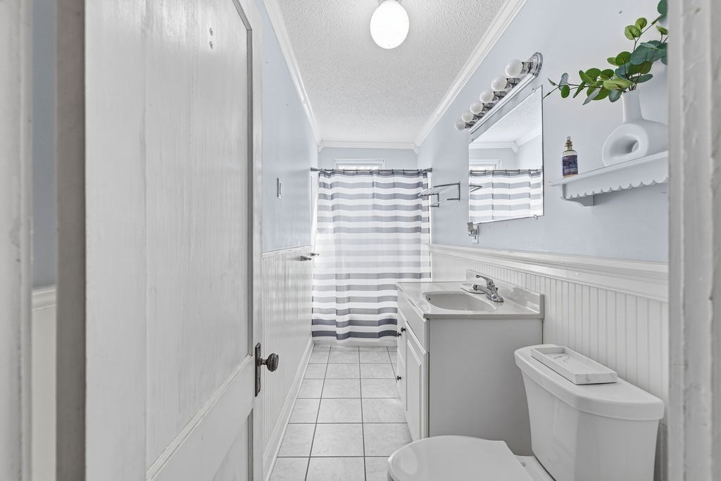 138 South Main Street, Unit 13 Fairhaven, MA 02719 - Photo 16 of 31 a bathroom with a toilet sink and mirror
