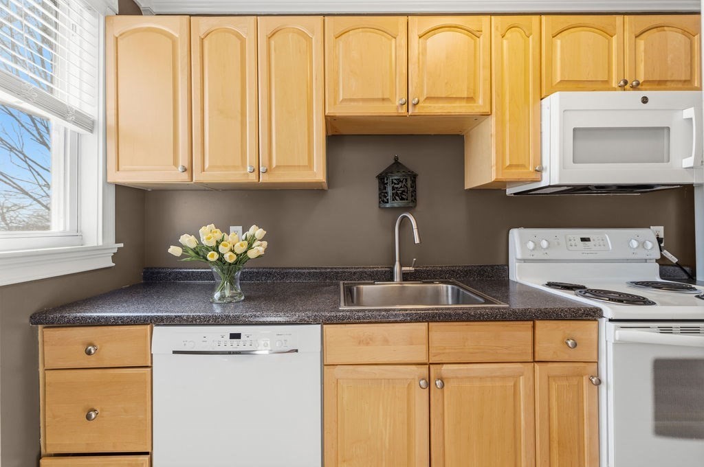 138 South Main Street, Unit 13 Fairhaven, MA 02719 - Photo 4 of 31 a kitchen with stainless steel appliances granite countertop a sink and cabinets