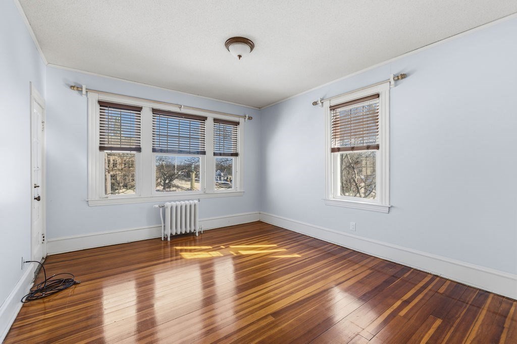 138 South Main Street, Unit 13 Fairhaven, MA 02719 - Photo 10 of 31 a view of empty room with wooden floor and fan