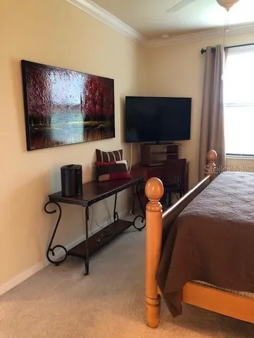 a bedroom with furniture and a flat screen tv