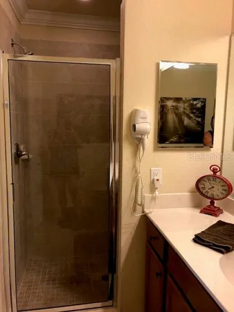 a bathroom with a sink a mirror and shower