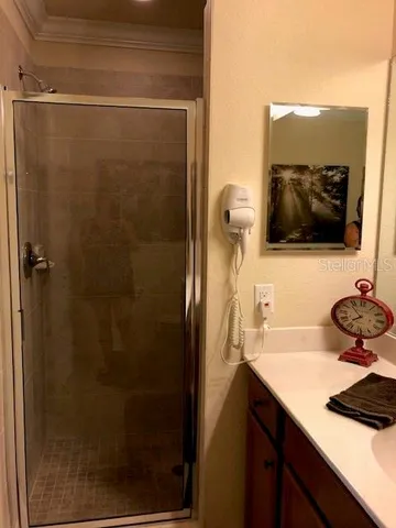 a bathroom with a sink a mirror and shower