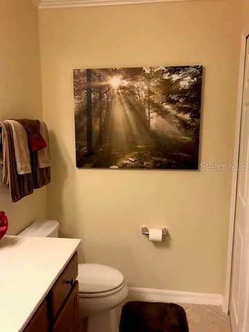 a bedroom with a bed and a lamp