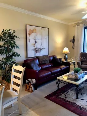a living room with furniture a lamp and a potted plant