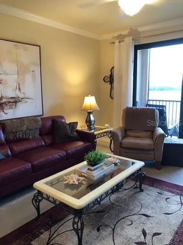 a living room with furniture a rug and a large window