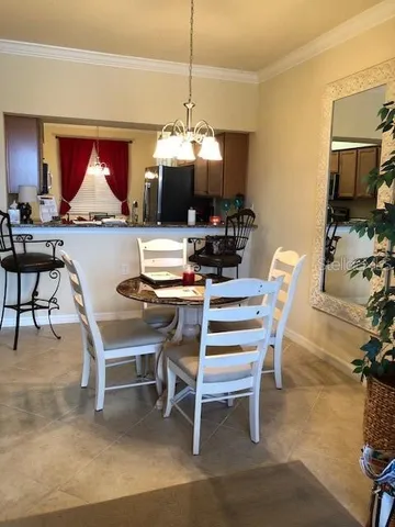 a dining room with furniture a rug and a chandelier