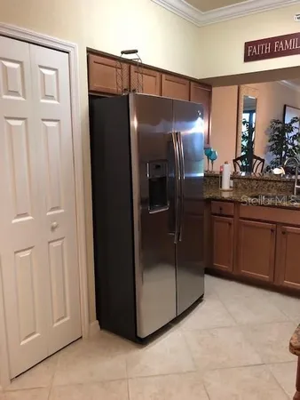 a kitchen with stainless steel appliances granite countertop a refrigerator and a sink