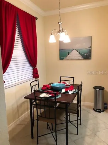 a view of a dining room with furniture and chandelier