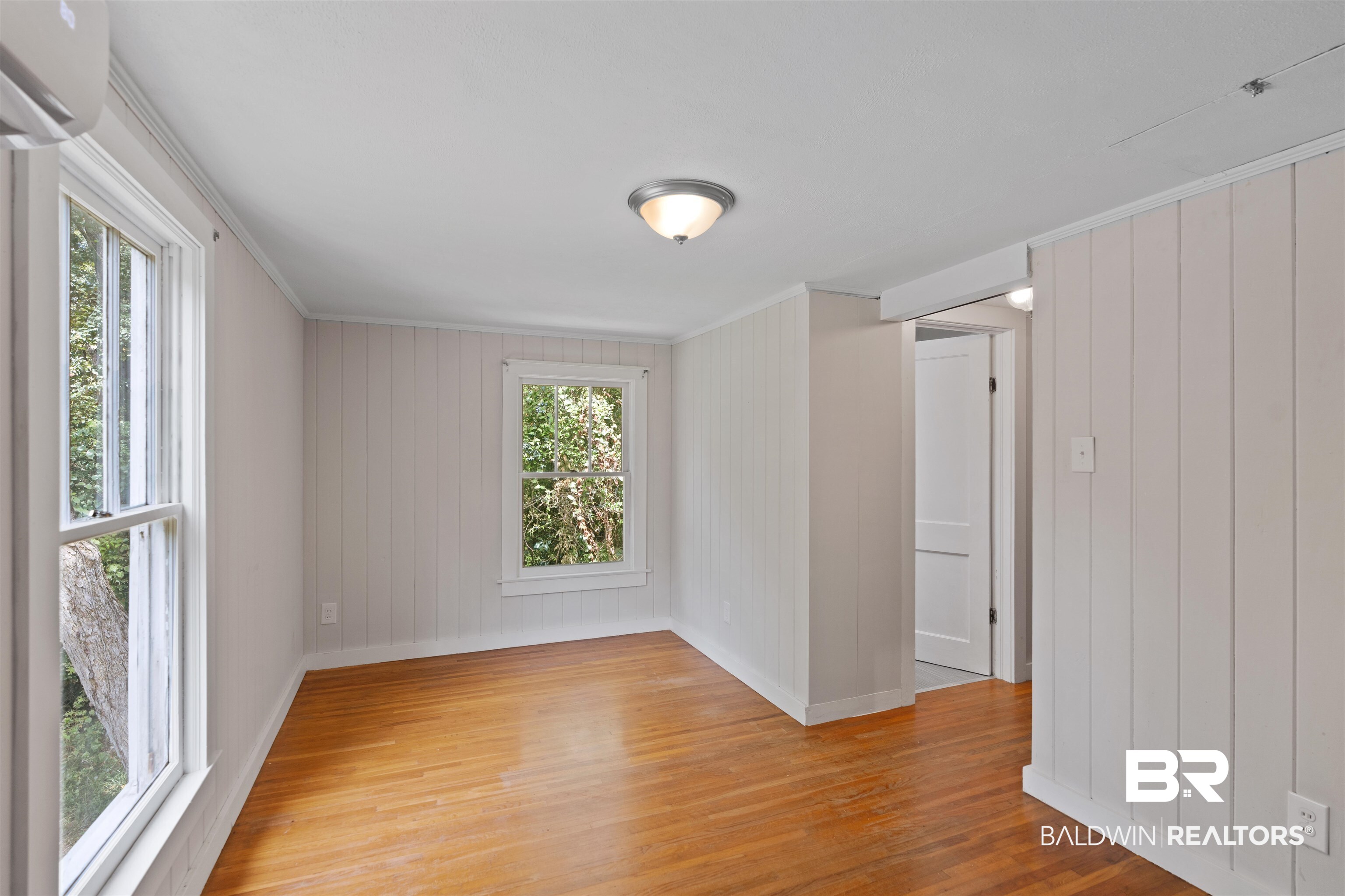 2126 Barron Place Mobile, AL 36605 - Photo 21 of 33 Spare room featuring light wood-type flooring, crown molding, and a wall unit AC