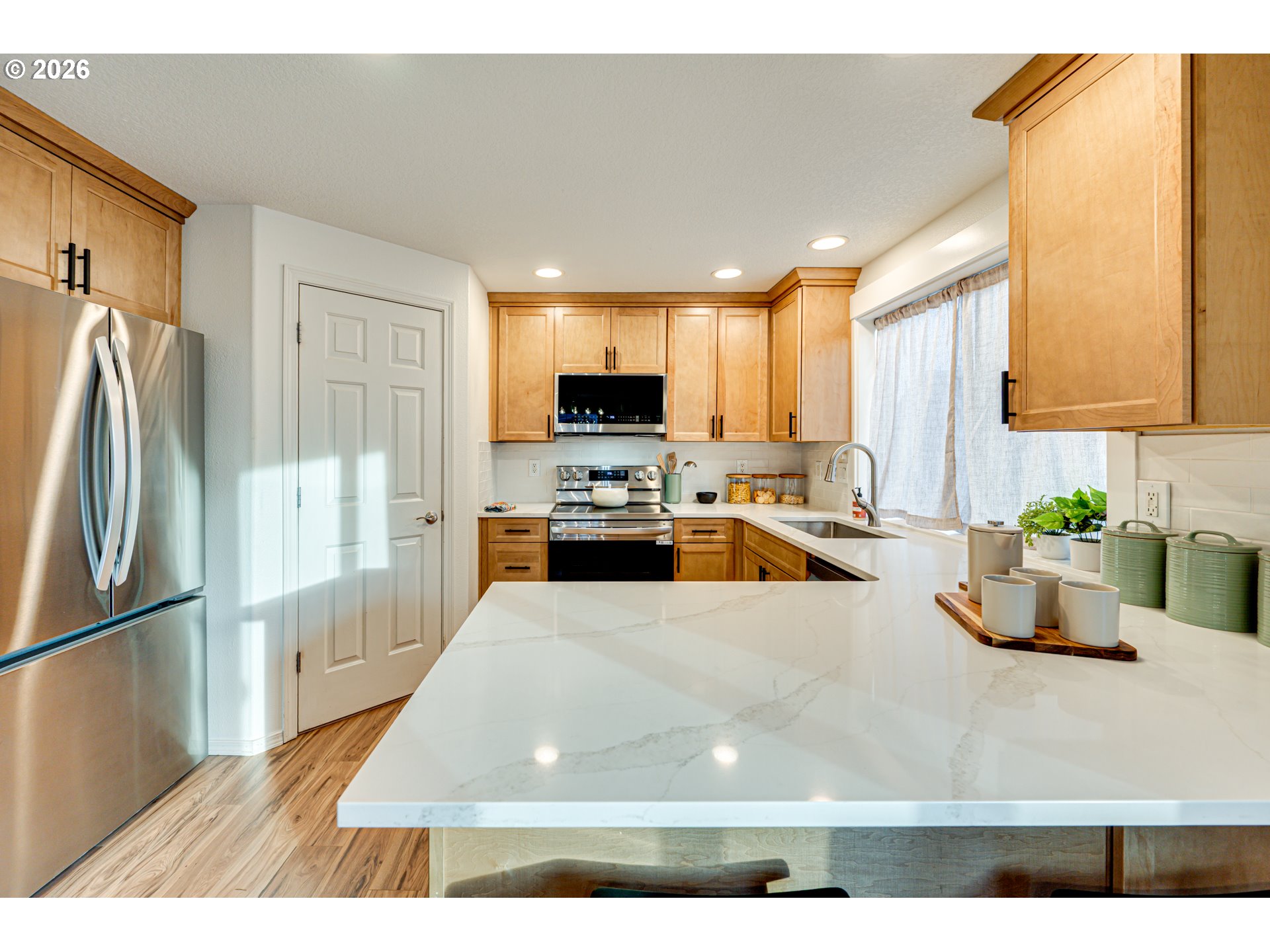 220 Mable Lane Woodland, WA 98674 - Photo 10 of 31 a kitchen with counter top space a sink a refrigerator and a view of living room