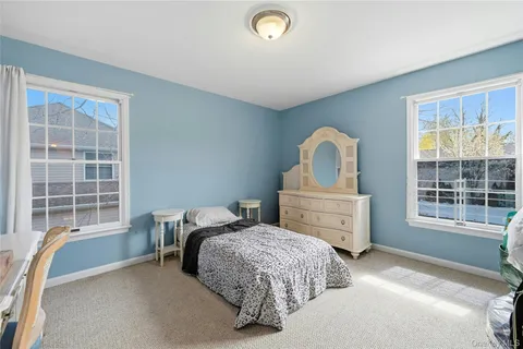 a bedroom with a bed next to a large window