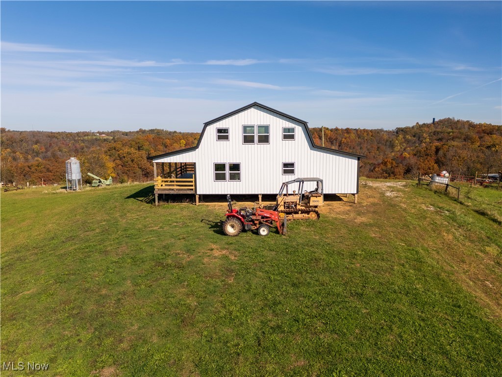 540 Wine Road Elizabeth, WV 26143 - Photo 46 of 49 Rear view of house with a yard, a view of trees, a wooden deck, and a gambrel roof