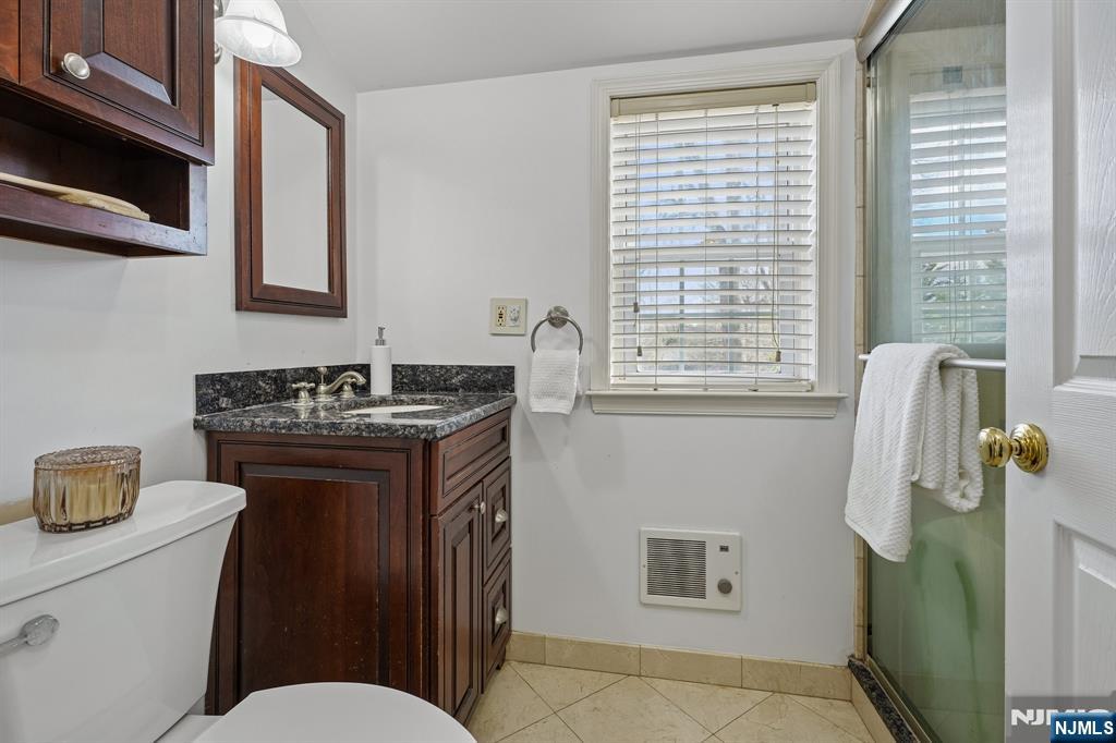 122 Johnson Avenue Mahwah, NJ 07430 - Photo 19 of 40 a bathroom with a granite countertop sink toilet and mirror