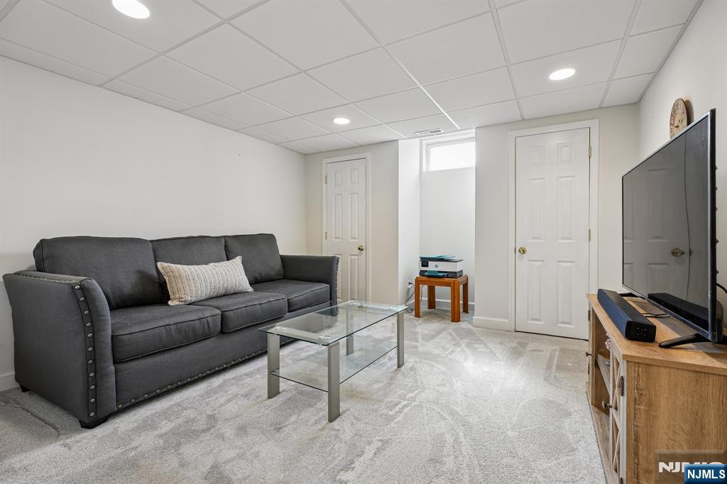 122 Johnson Avenue Mahwah, NJ 07430 - Photo 20 of 40 a living room with furniture and a flat screen tv