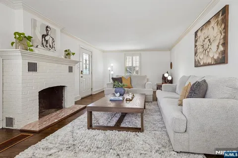 a living room with furniture a fireplace and a window