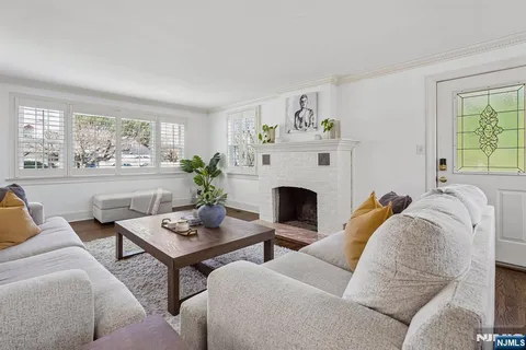 a living room with furniture fireplace and window