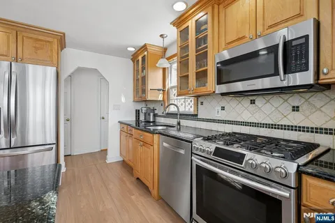 a kitchen with stainless steel appliances a stove a microwave and cabinets