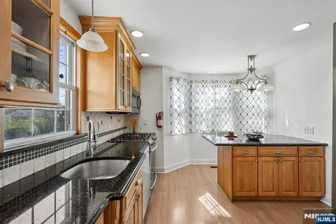 a kitchen with a sink cabinets and window