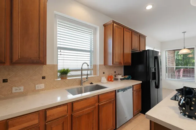 a kitchen with kitchen island a sink stove and refrigerator