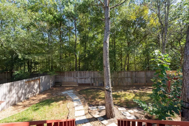 a view of a backyard with a small cabin and a chair