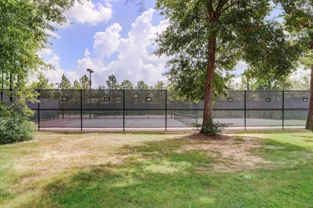 a view of a yard with wooden fence