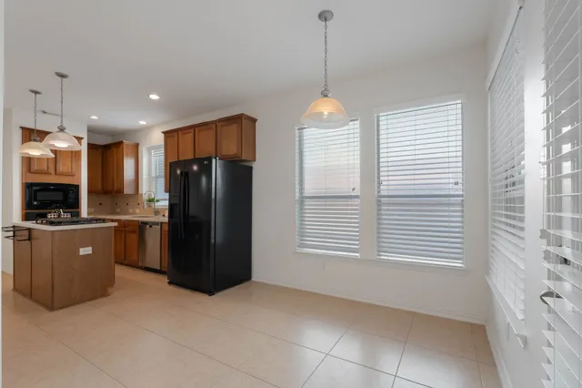 a kitchen with stainless steel appliances granite countertop a refrigerator and a sink