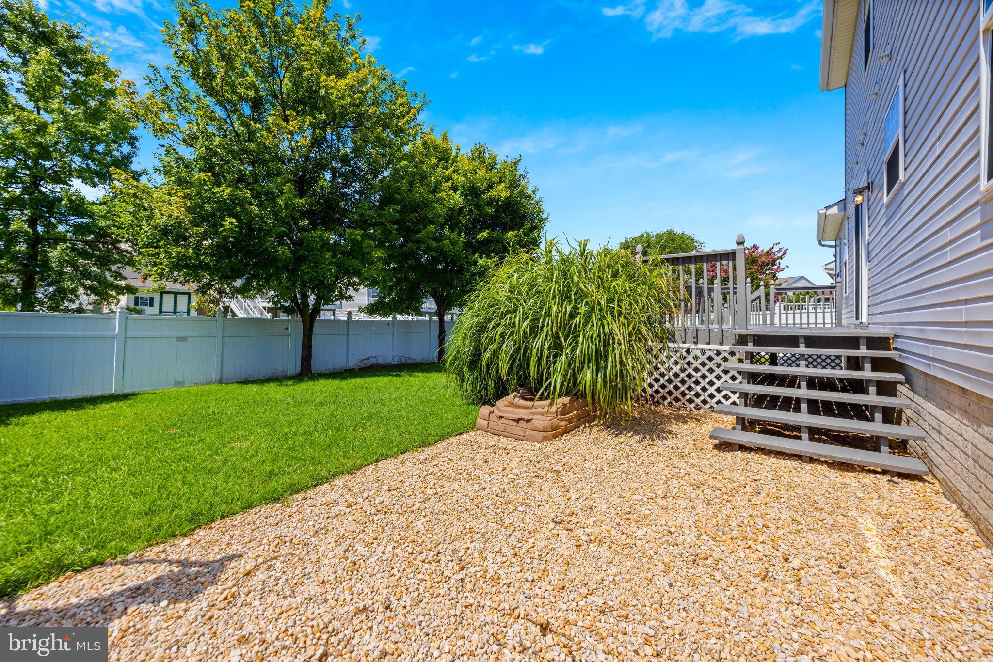 4613 Sandwood Road Sparrows Point, MD 21219 - Photo 44 of 68 Sunny backyard oasis with lush greenery.