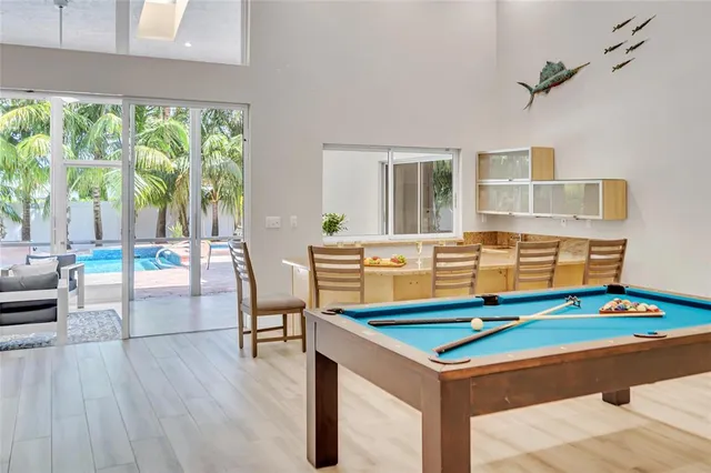 a kitchen with granite countertop white cabinets a sink a window and stainless steel appliances