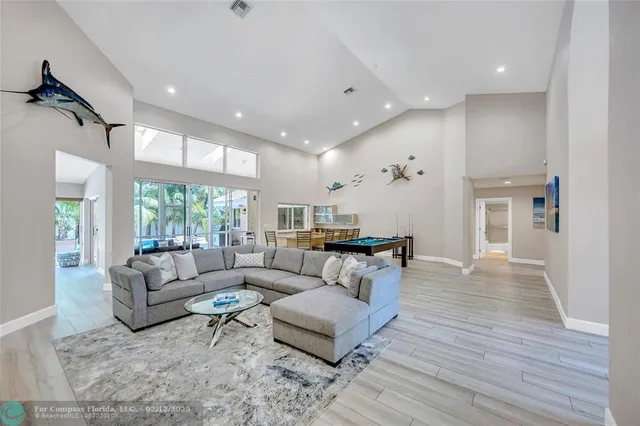 a room with furniture pool table and windows