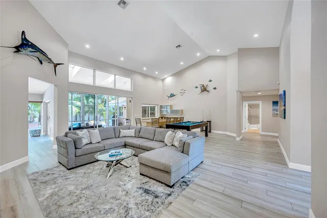 a room with furniture pool table and windows