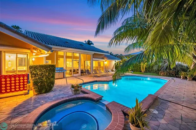 a spacious bedroom with a bed and a chandelier