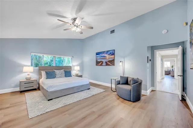 a spacious bedroom with a bed and furniture