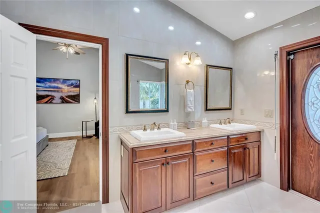 a spacious bathroom with a tub shower and mirror
