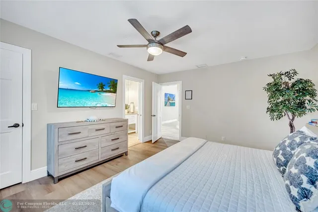 a bathroom with a granite countertop sink a toilet a mirror and shower