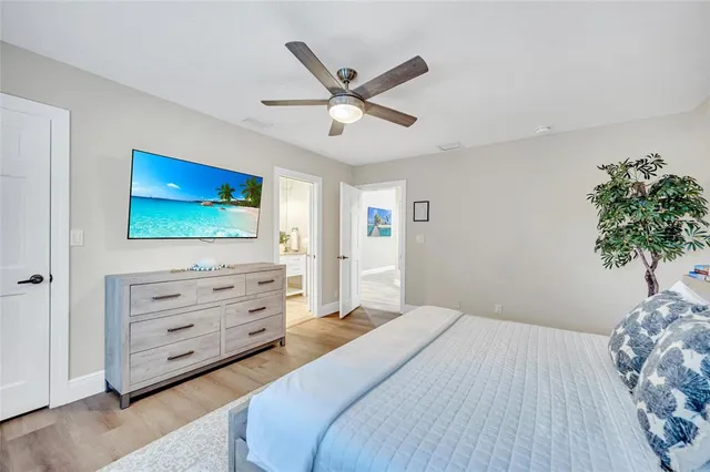 a bathroom with a granite countertop sink a toilet a mirror and shower