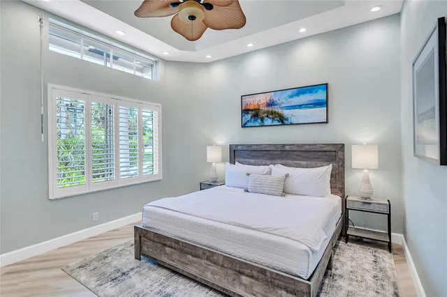 a bedroom with a bed and glass window