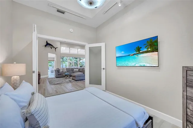 a bedroom with a bed and a flat screen tv