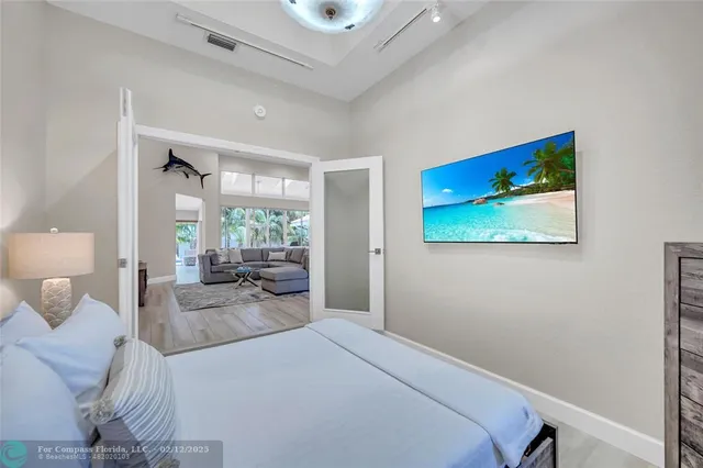 a bedroom with a bed and a flat screen tv