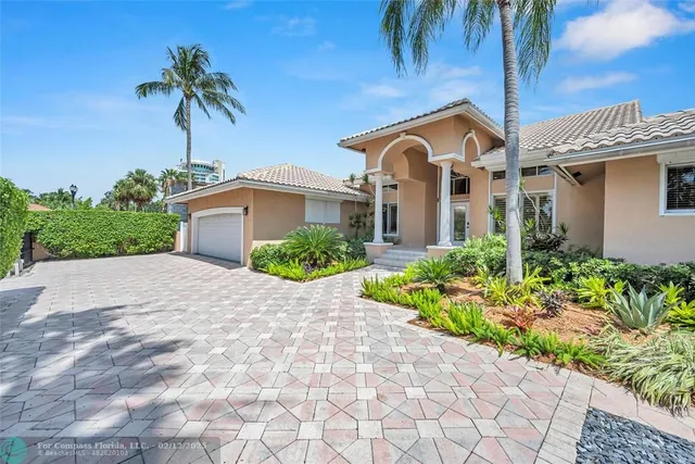a green field with lots of trees in front of it