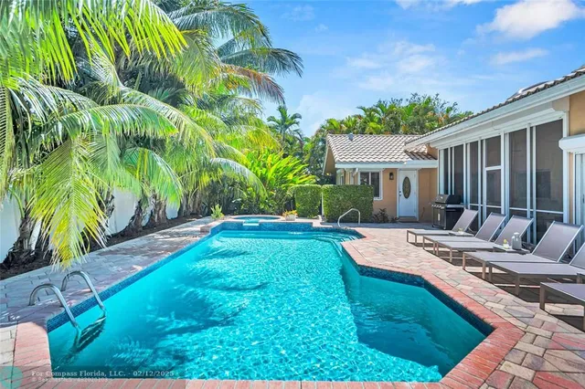a view of a park with plants and brick wall