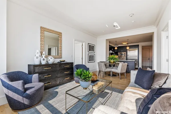 a living room with furniture potted plant and a mirror
