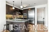 a kitchen with stainless steel appliances granite countertop a sink a refrigerator and a granite counter tops