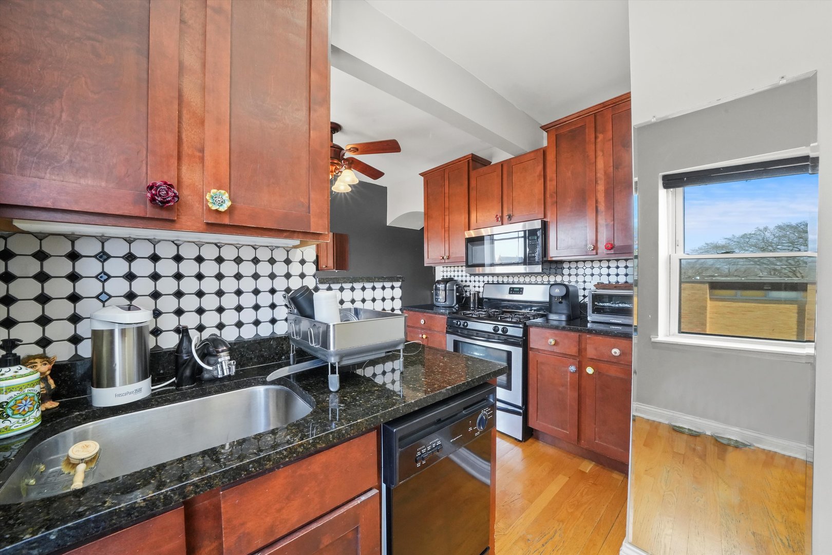 52 Forest Avenue, Unit 2S Riverside, IL 60546 - Photo 19 of 43 a kitchen with kitchen island granite countertop a sink stove and cabinets