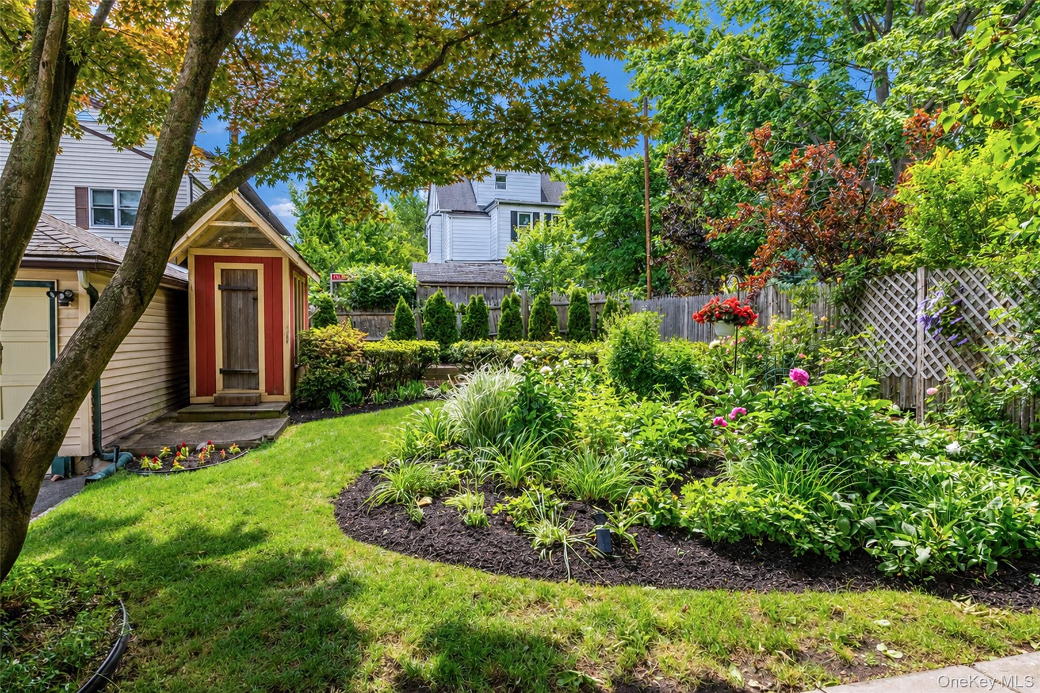 82 Clove Road New Rochelle, NY 10801 - Photo 35 of 39 a view of a house with a small yard and a large tree